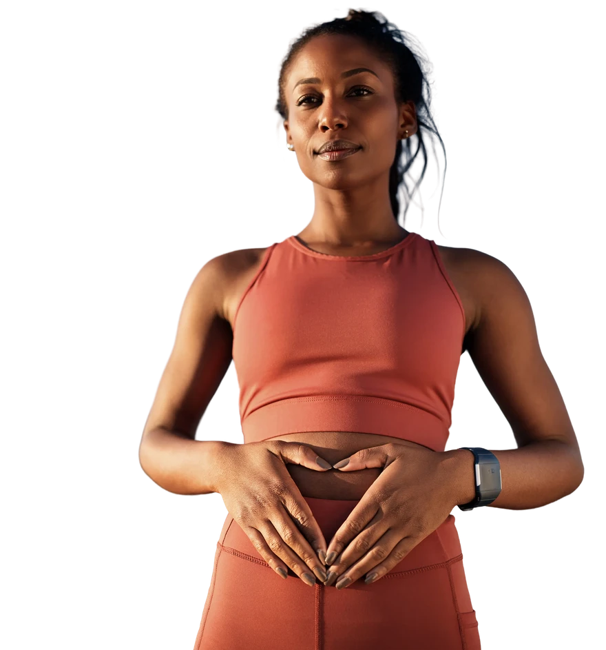 Woman forming a heart shape with her hands over her stomach